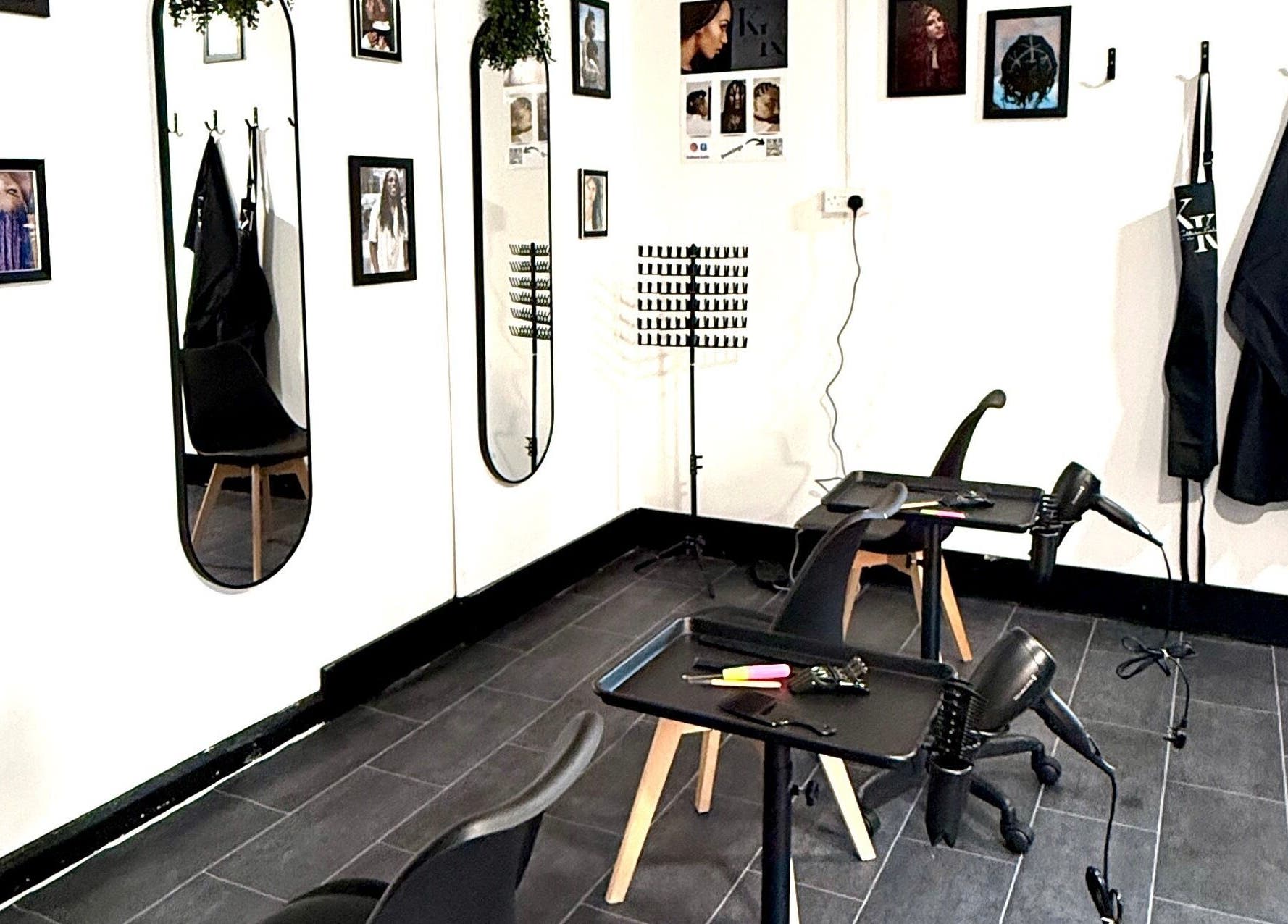 Modern styling station at Kulture Kurls, Whitley Bay, GB with mirrors and decor.