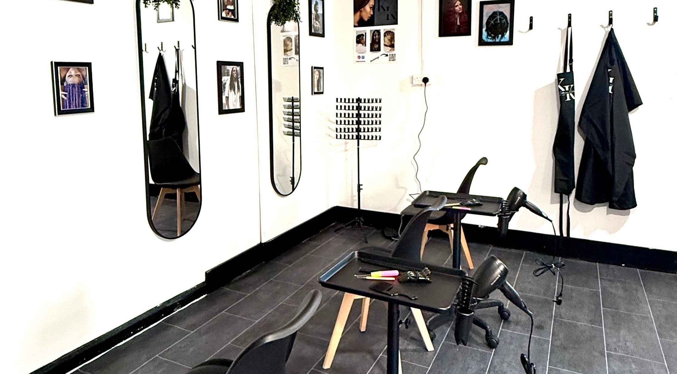 Modern styling station at Kulture Kurls, Whitley Bay, GB with mirrors and decor.