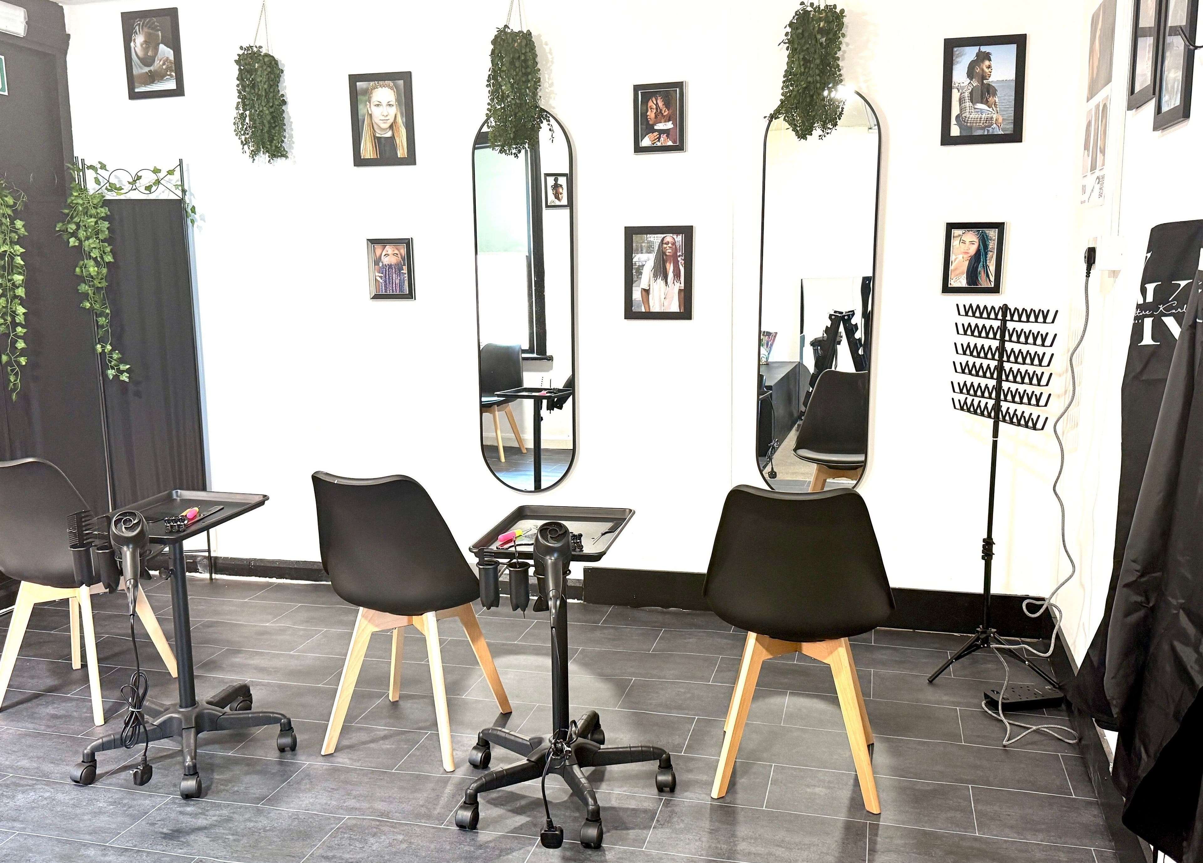 Modern styling station at Kulture Kurls, Whitley Bay, GB with mirrors and chic chairs.
