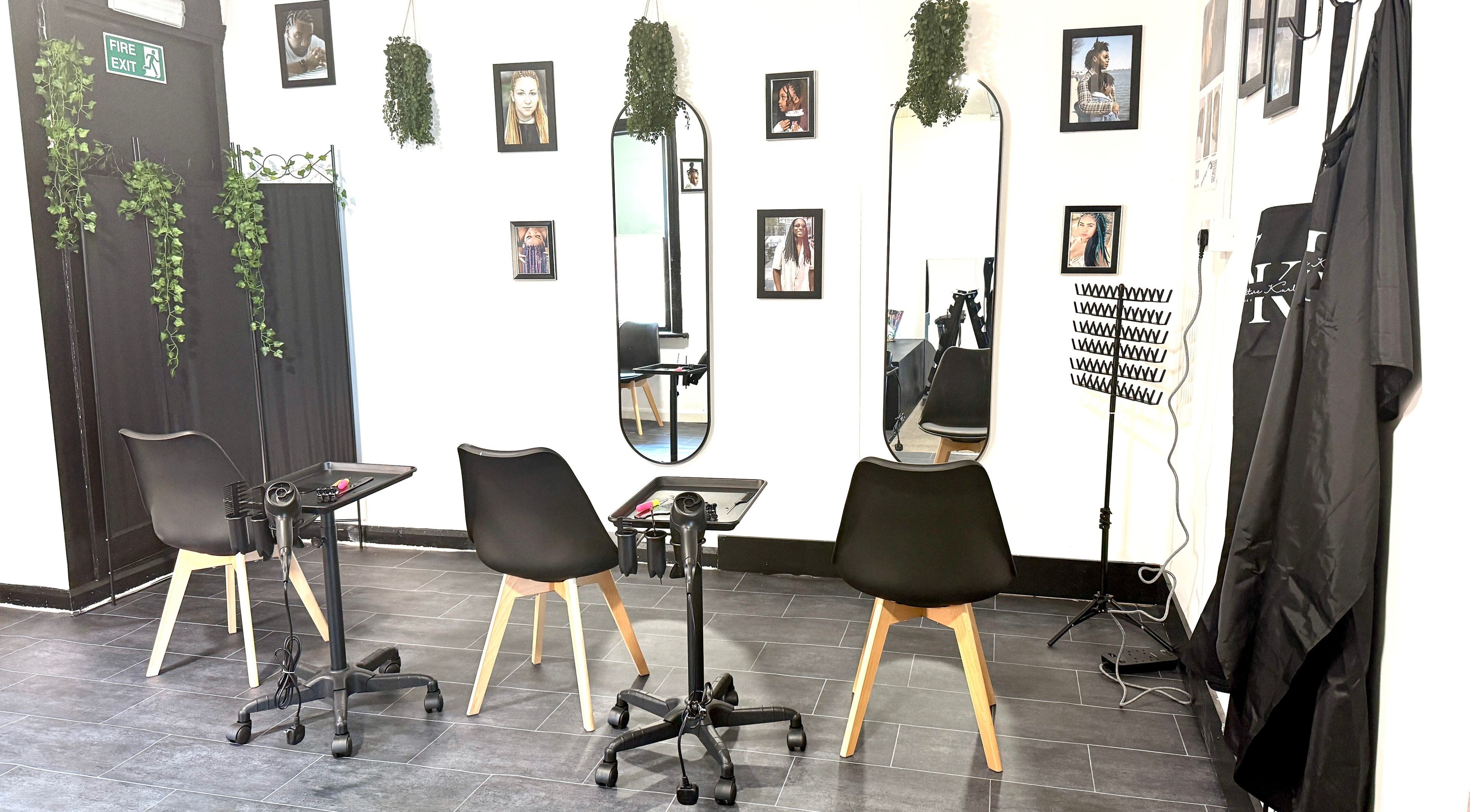Modern styling station at Kulture Kurls, Whitley Bay, GB with mirrors and chic chairs.