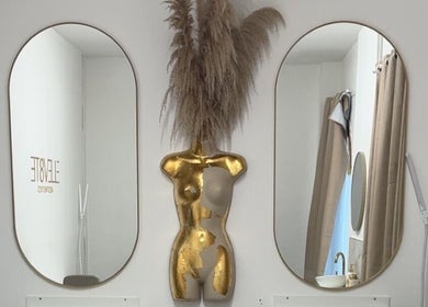 NV Aesthetics decor in Syston, England, GB featuring mirrors and a gold torso sculpture.