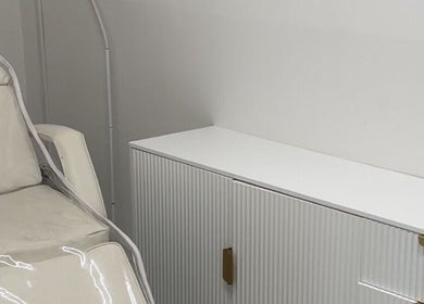 Inviting treatment chair and sleek cabinet at NV Aesthetics, Syston, England, GB, for relaxing wellness sessions.