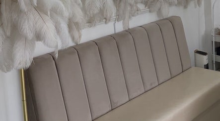 Elegant beige seating with feather decor at NV Aesthetics, Syston, England, GB.