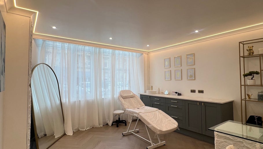 Relaxing treatment room at HM Advanced Aesthetics in Glasgow, Scotland, GB with modern decor and natural light.