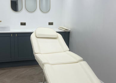 Elegant treatment room at HM Advanced Aesthetics, Glasgow, Scotland, GB featuring a pristine white chair.