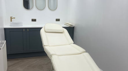 Elegant treatment room at HM Advanced Aesthetics, Glasgow, Scotland, GB featuring a pristine white chair.
