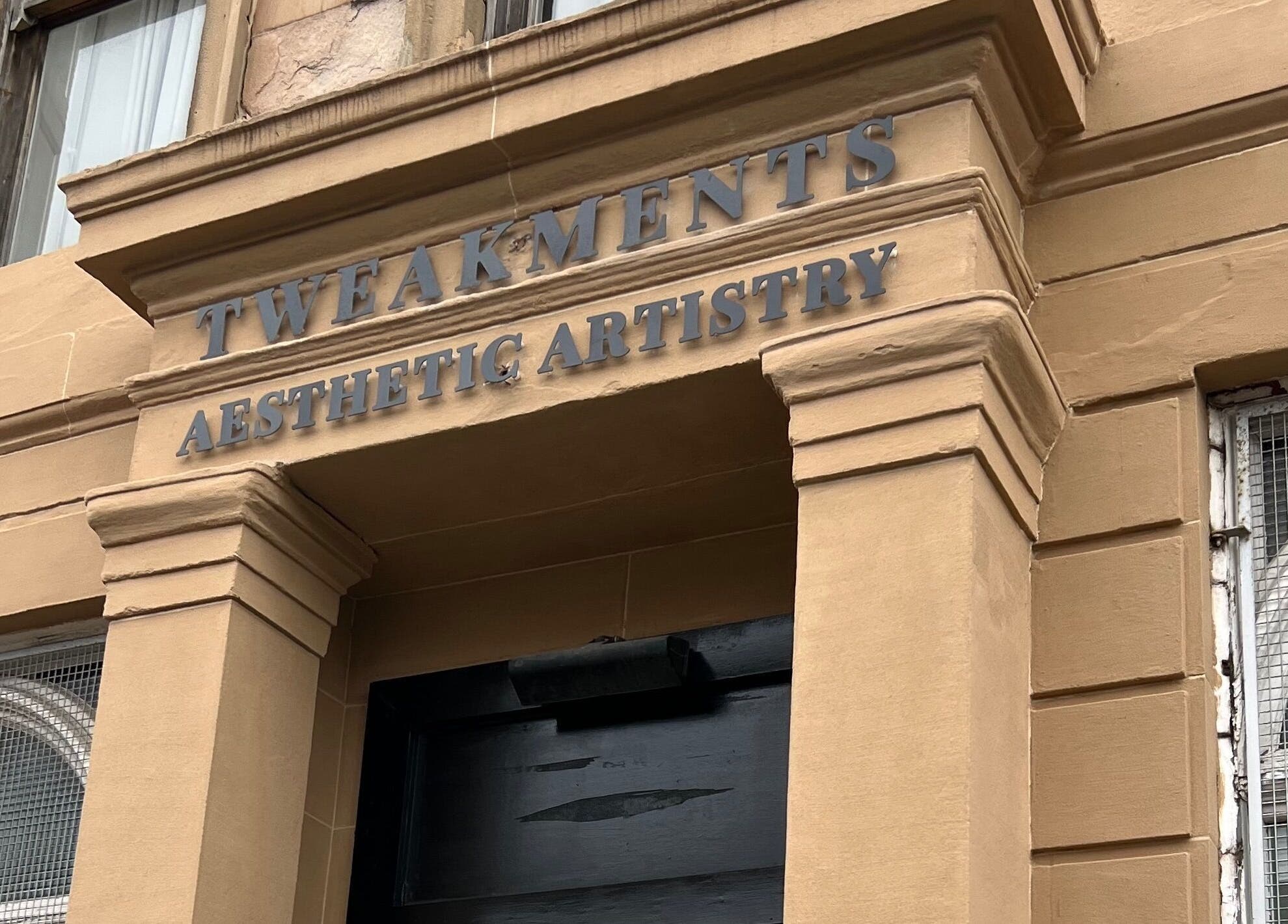 HM Advanced Aesthetics entrance in Glasgow, Scotland, showcasing elegant stone facade.