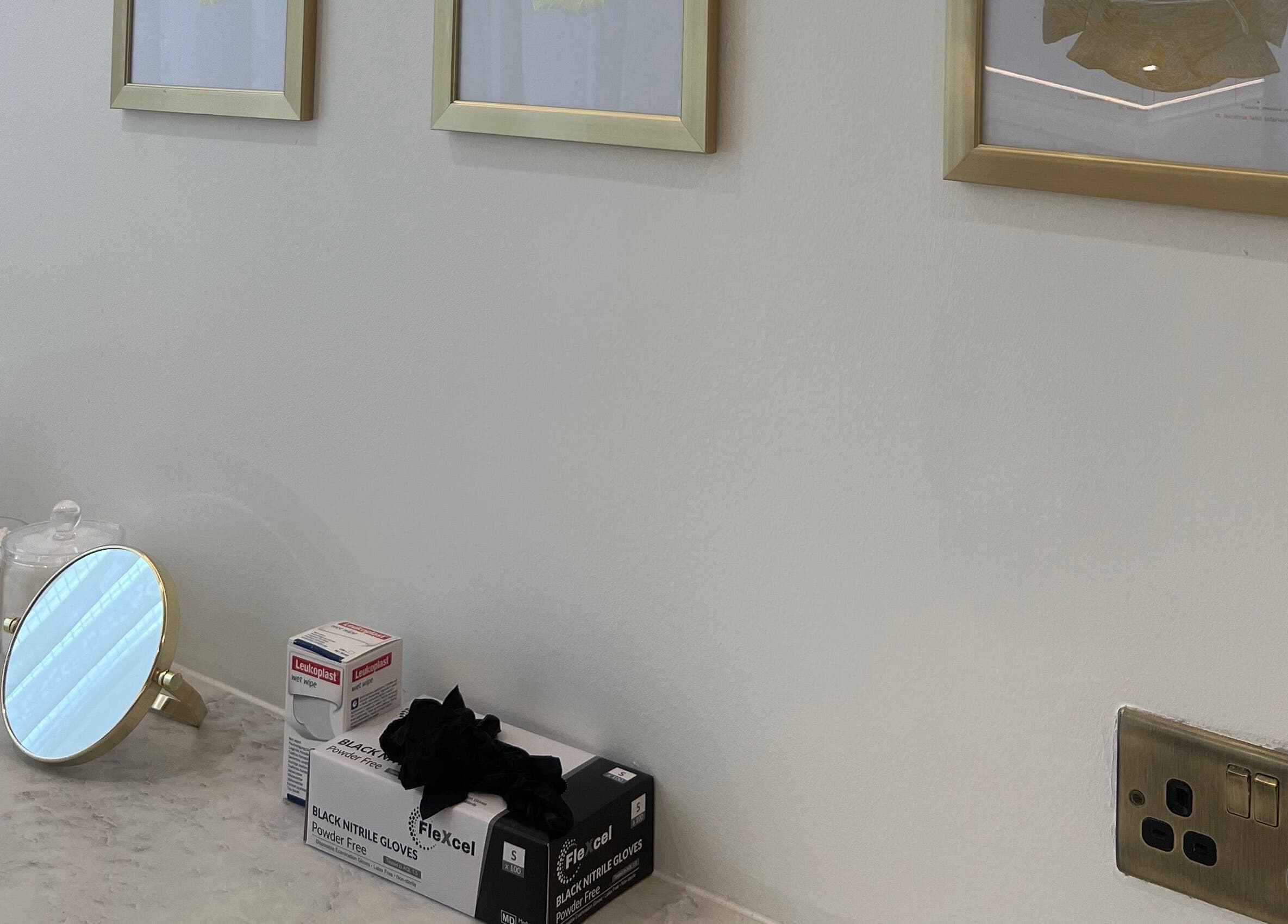 Elegant vanity corner at HM Advanced Aesthetics, Glasgow, Scotland, GB. Features mirror and skincare items.