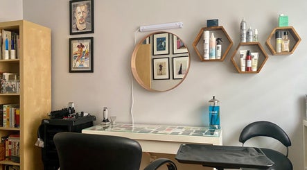 Stylish salon interior at HAIRBÜRY, Montréal, Québec, CA, featuring modern decor and haircare products.