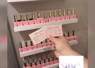 Nails by Grace in Gosport, England showcasing nail polish and loyalty cards on a display shelf.