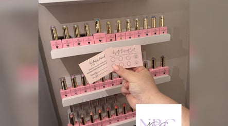 Nails by Grace in Gosport, England showcasing nail polish and loyalty cards on a display shelf.