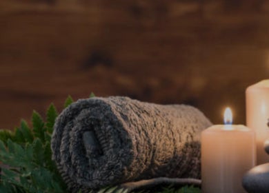 Relaxing setup at Layered Knots, LLC in Martinsville, Virginia with candles, towels, and stones.