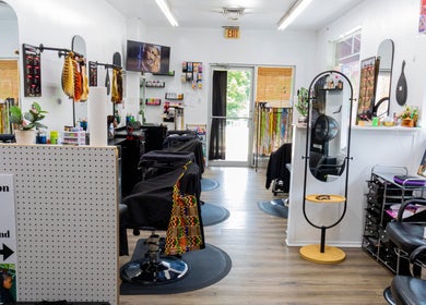 Interior of BraidingLand Hair Salon in Gaithersburg, Maryland, US, showcasing stylish chairs and decor.