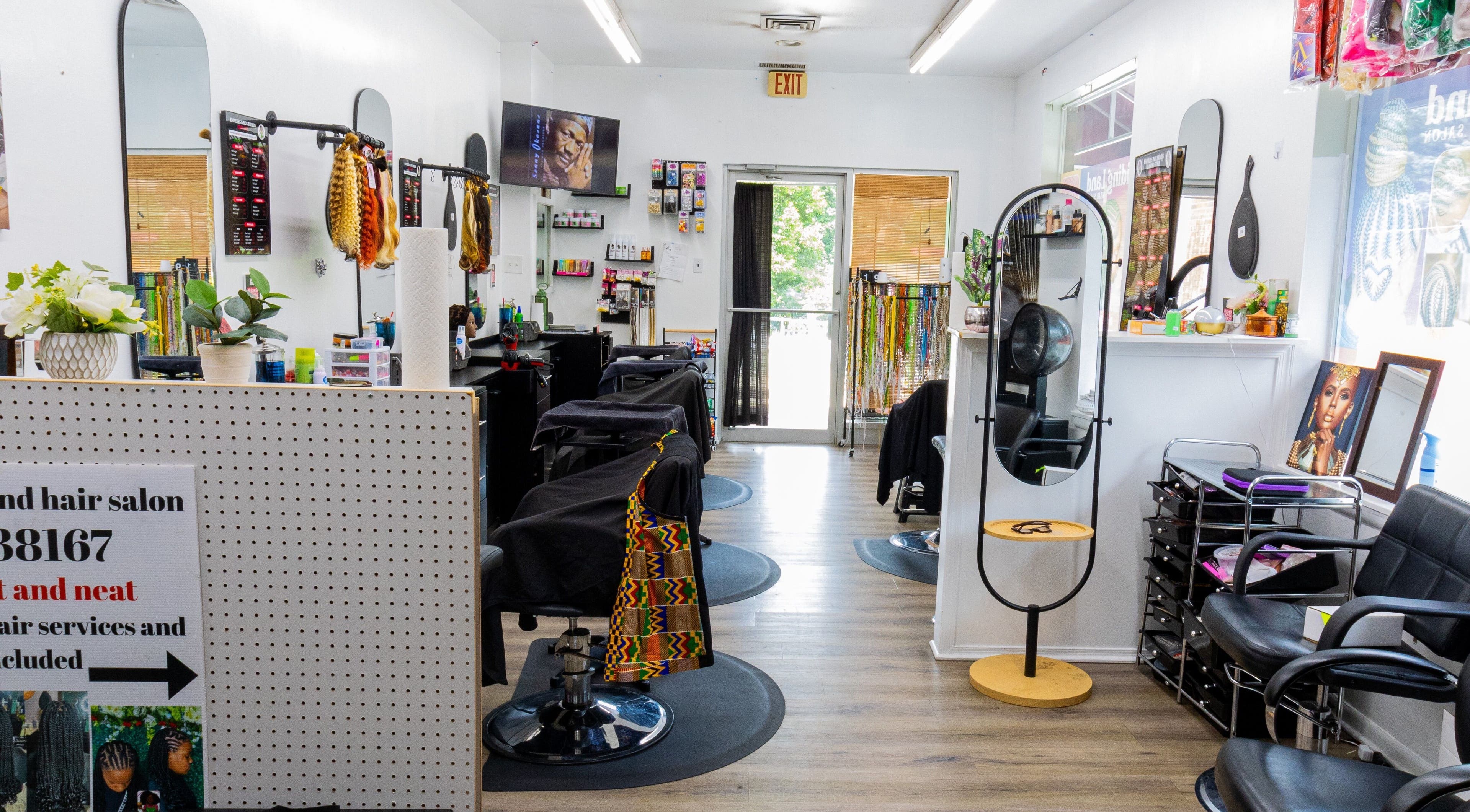 Interior of BraidingLand Hair Salon in Gaithersburg, Maryland, US, showcasing stylish chairs and decor.