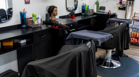 Interior view of BraidingLand Hair Salon in Gaithersburg, Maryland, US, showcasing stylist stations and beauty products.