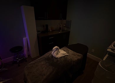 Cozy treatment room at Glow & Grace Esthetics in Calgary, Alberta, CA, featuring a plush treatment bed and ambient lighting.