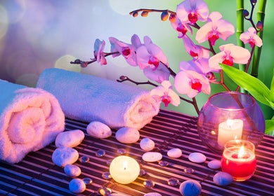 KAESTHETICS 5th dimension spa suite in Richmond, Kentucky offers a tranquil setting with candles and orchids.