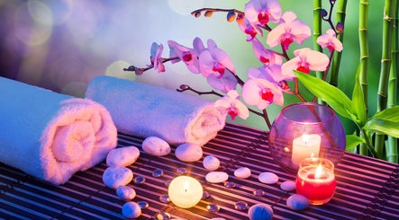 KAESTHETICS 5th dimension spa suite in Richmond, Kentucky offers a tranquil setting with candles and orchids.