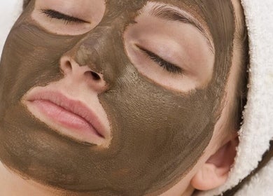 Calm woman enjoying a mud mask at KAESTHETICS 5th dimension spa suite, Richmond, Kentucky, US.