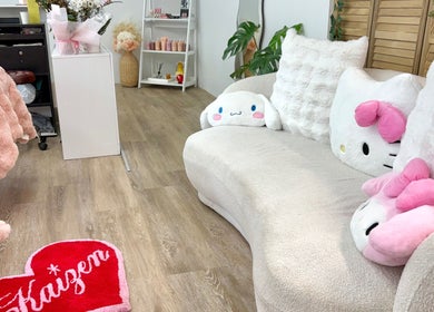 Inviting soft pink decor at KAIZEN beauty lounge in Pyrmont, New South Wales, AU showcasing plush seating.