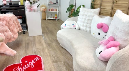 Inviting soft pink decor at KAIZEN beauty lounge in Pyrmont, New South Wales, AU showcasing plush seating.