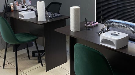 Elegant nail station at Nailcraftsbynene in Pretoria, Gauteng, ZA with green chairs and manicure tools.
