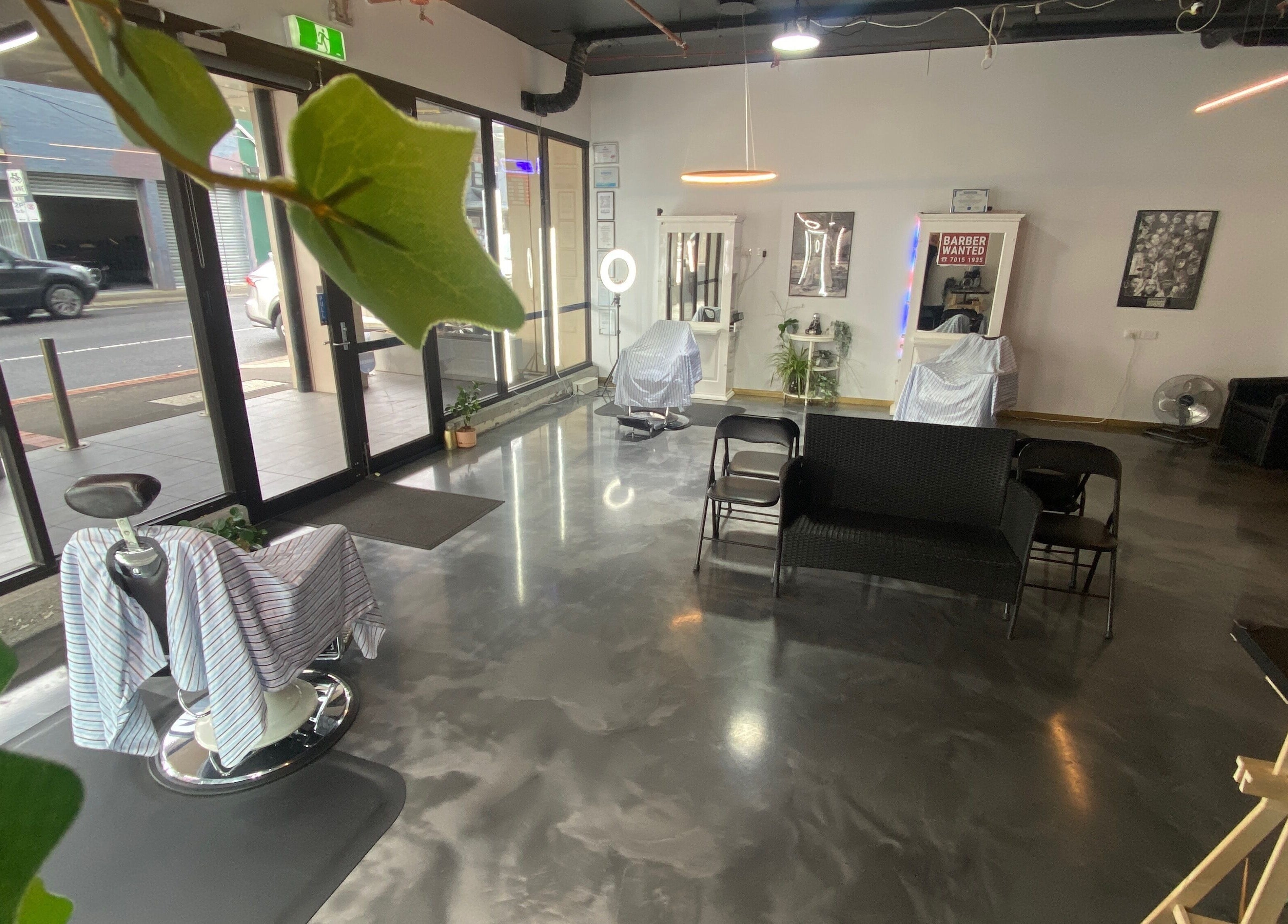 Inside Silk Barbershop Carnegie, Melbourne, showing modern chairs and sleek decor for a relaxing experience.