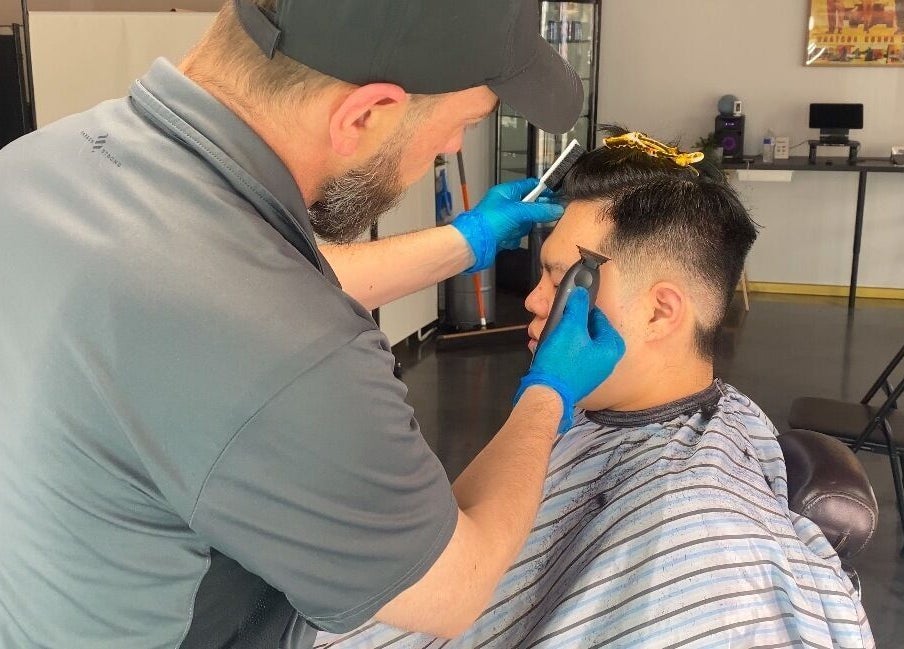 Professional barber styling a client's hair at Silk Barbershop Carnegie, Melbourne, Victoria, AU.