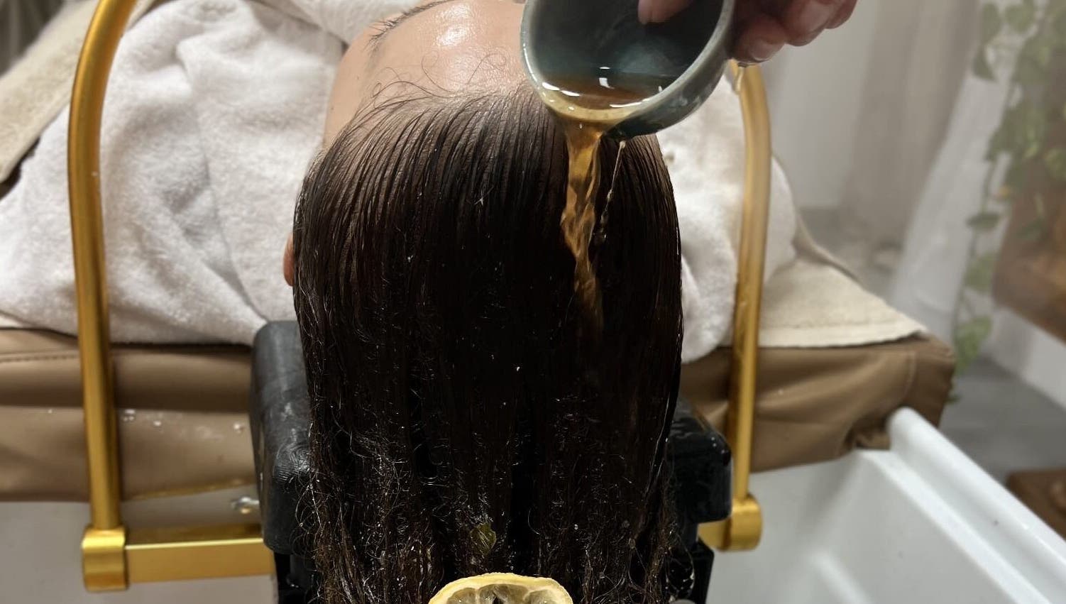 Relaxing herbal hair treatment at Maison Juline, Il-GZIRA, MT, featuring a rejuvenating rinse for silky smooth hair.