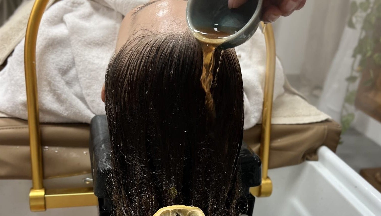 Relaxing herbal hair treatment at Maison Juline, Il-GZIRA, MT, featuring a rejuvenating rinse for silky smooth hair.