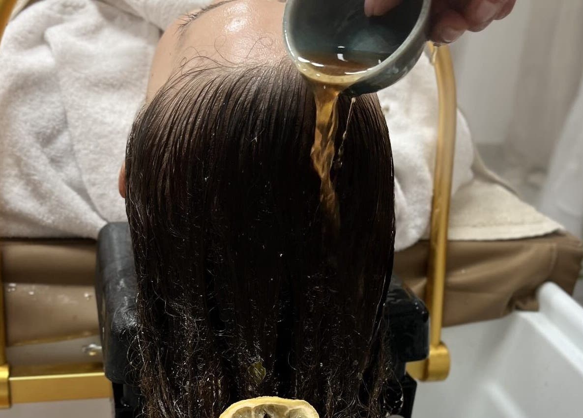 Relaxing herbal hair treatment at Maison Juline, Il-GZIRA, MT, featuring a rejuvenating rinse for silky smooth hair.