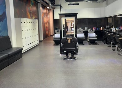 Modern interior of The Broadway Hair Salon in Worthing, England, GB, showcasing stylish chairs and vibrant wall art.