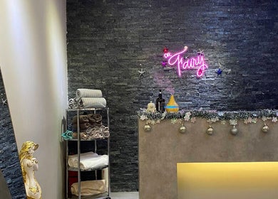 Welcome desk at Dear Fairy Beauty in Kuala Lumpur, adorned with towels and decor.