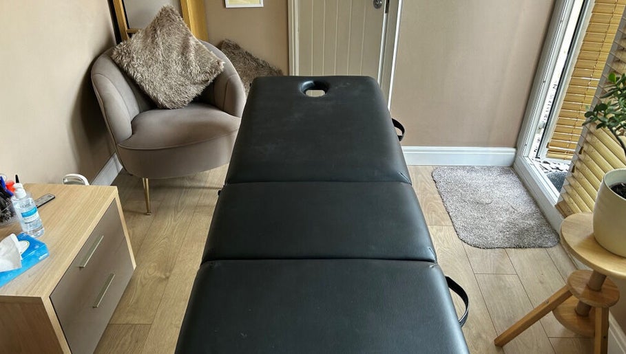 Massage room at Manchester Athletic Recovery Sports Massage Therapy in Worsley, England, GB, featuring a plush chair.