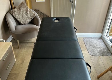Massage room at Manchester Athletic Recovery Sports Massage Therapy in Worsley, England, GB, featuring a plush chair.