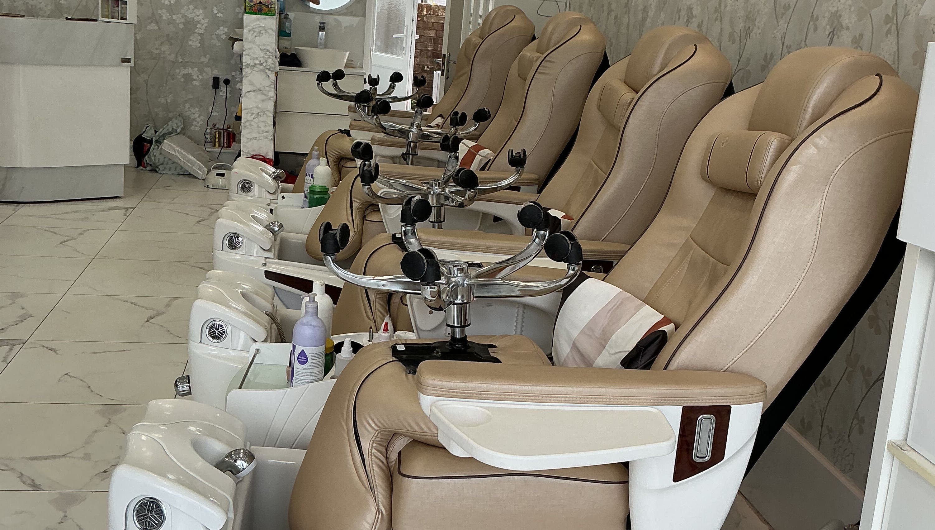 Luxurious pedicure chairs at Maya Nails, Ashtead, England, GB, offering comfort and elegance in a serene setting.