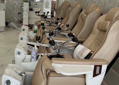 Luxurious pedicure chairs at Maya Nails, Ashtead, England, GB, offering comfort and elegance in a serene setting.