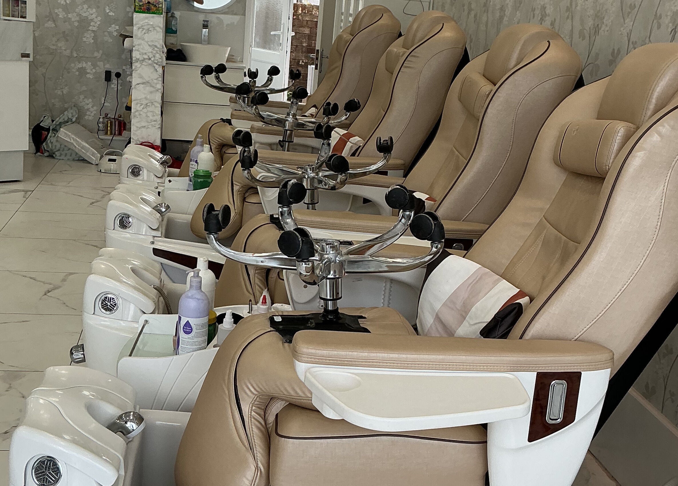 Luxurious pedicure chairs at Maya Nails, Ashtead, England, GB, offering comfort and elegance in a serene setting.