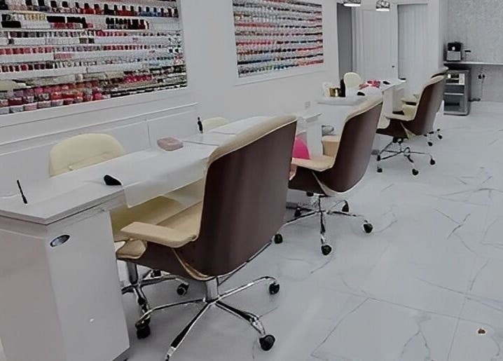 Spacious, modern interior of Maya Nails, Ashtead, England, GB with sleek manicure stations.
