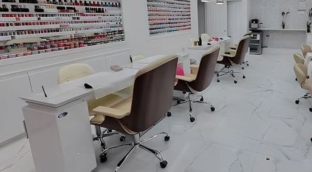 Spacious, modern interior of Maya Nails, Ashtead, England, GB with sleek manicure stations.