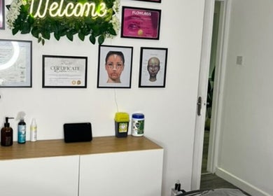 Interior view of Vasilica Manchester Aesthetics in Dukinfield, England featuring a welcoming display and certificates.
