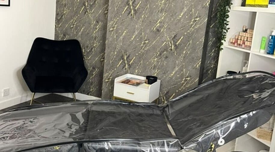 Luxurious treatment room at Vasilica Manchester Aesthetics, Dukinfield, England, with modern decor and sleek furniture.