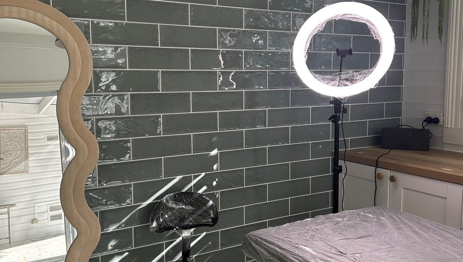 Modern beauty treatment area at Haven Ink & Beauty Studio in Perth, Western Australia, AU with mirror and ring light.