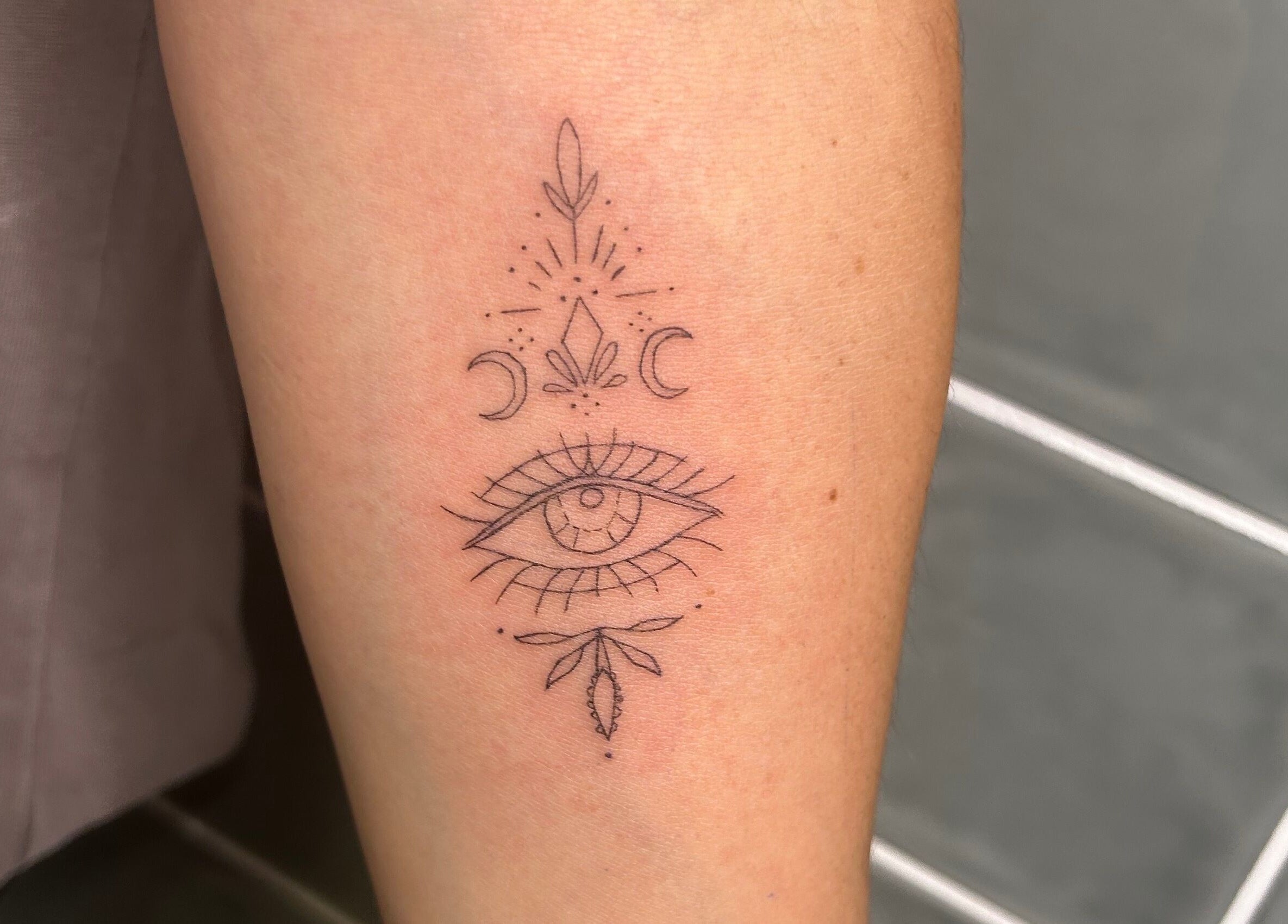 Detailed eye tattoo with mystical symbols at Haven Ink & Beauty Studio, Dawesville, Western Australia, AU.