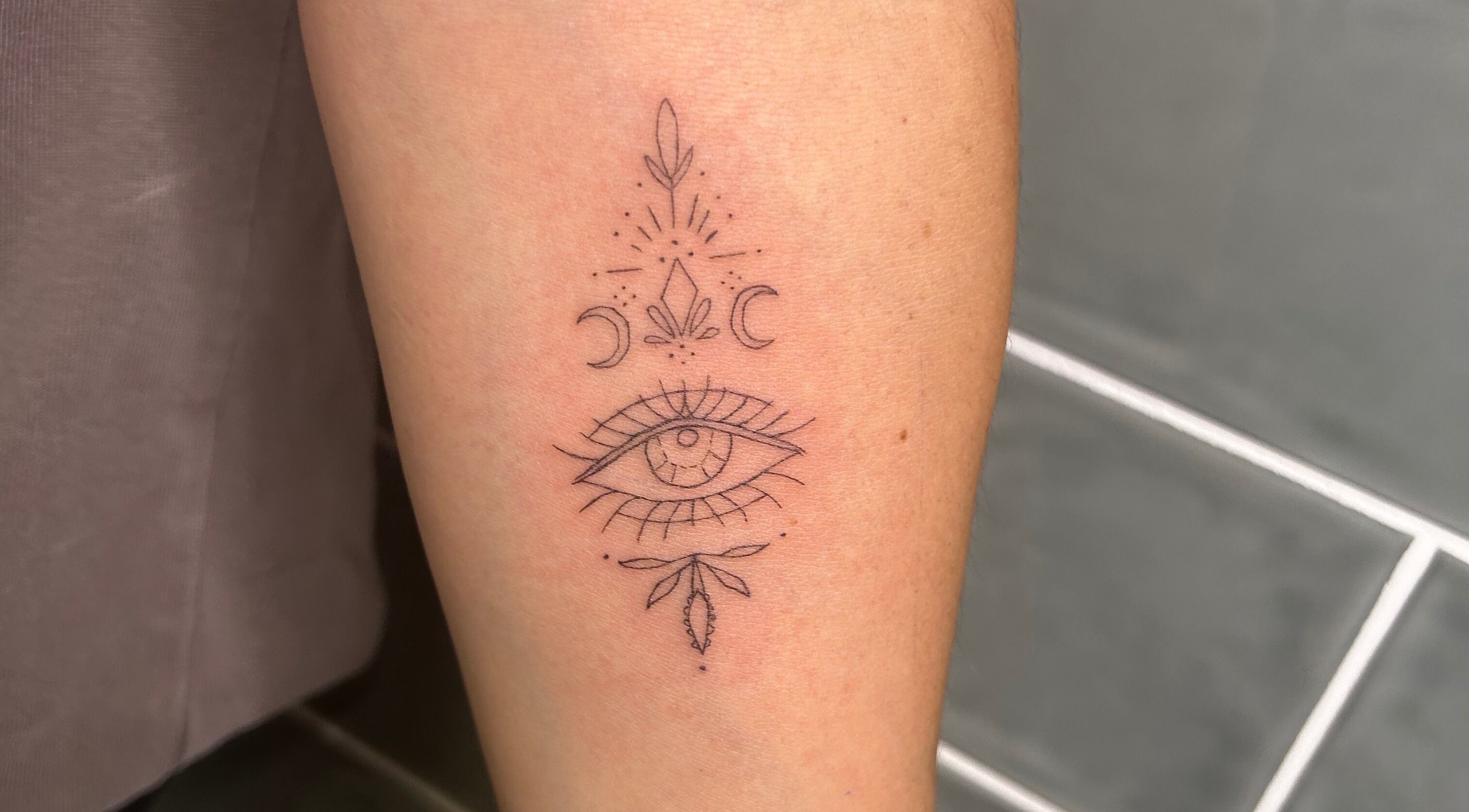 Detailed eye tattoo with mystical symbols at Haven Ink & Beauty Studio, Dawesville, Western Australia, AU.