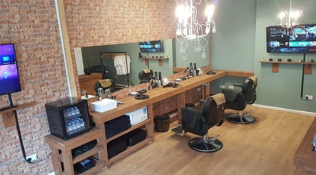 Interior of Cutthroat Jacks Edgeley in Stockport, England, GB, featuring rustic decor and modern barber stations.