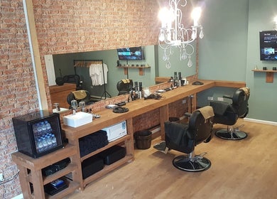 Elegant barber space at Cutthroat Jacks Edgeley, Stockport, England, GB with vintage decor and plush seats.