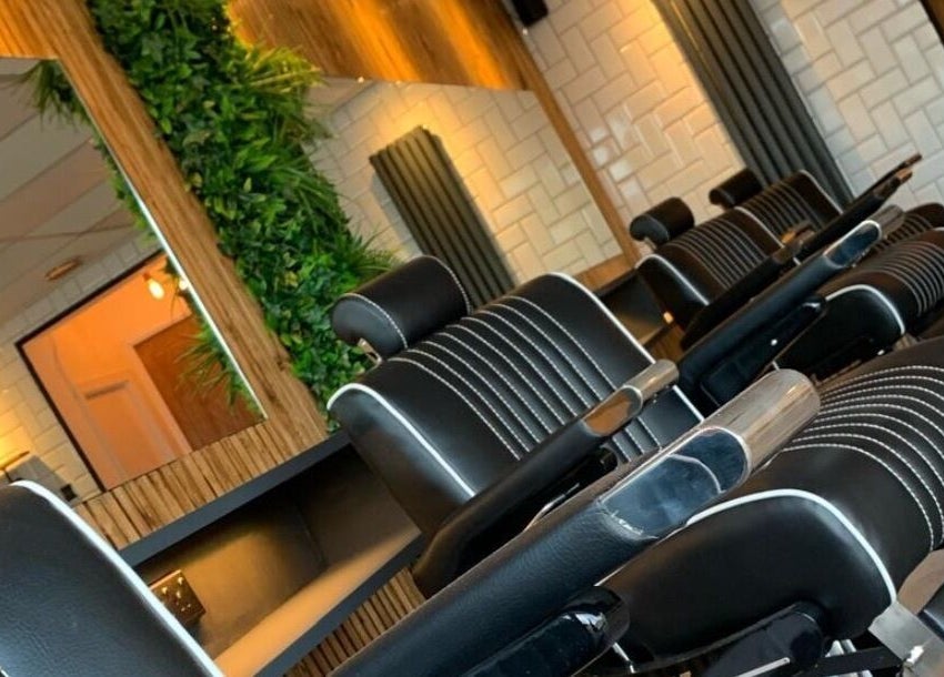 Elegant barber chairs at Cutthroat Jacks, Stockport, England, GB, reflecting a modern and relaxing atmosphere.