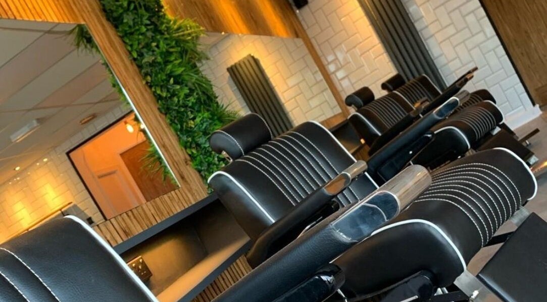Elegant barber chairs at Cutthroat Jacks, Stockport, England, GB, reflecting a modern and relaxing atmosphere.