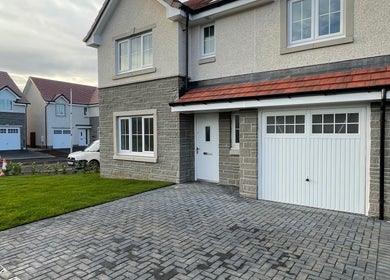 Modern residential exterior near KB Nails, Livingston, Scotland, GB, highlighting clean design and structure.